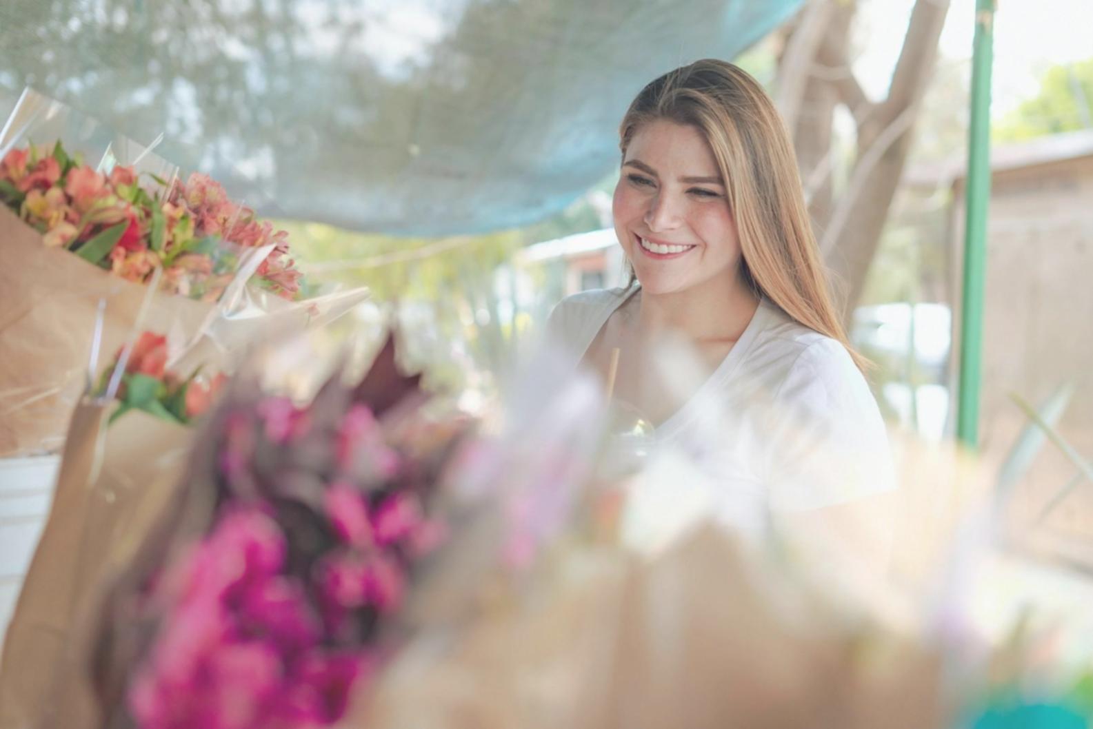 Professional floral arrangement workspace showing design tools and fresh flowers